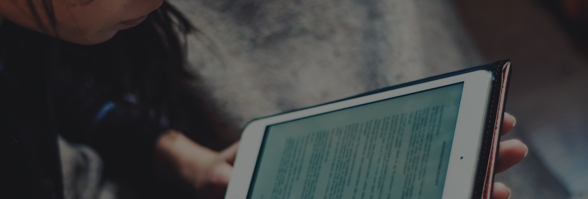 Person reading on a tablet device.